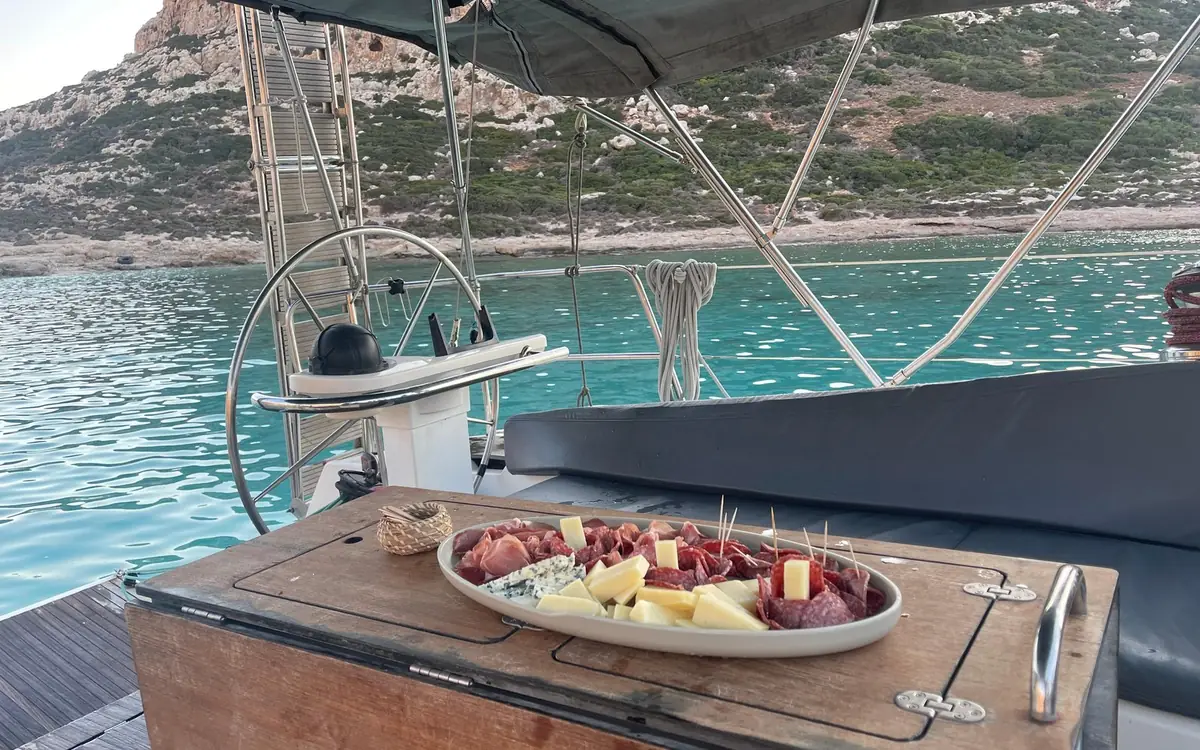 A platter of snacks on a table aboard a sailing catamaran